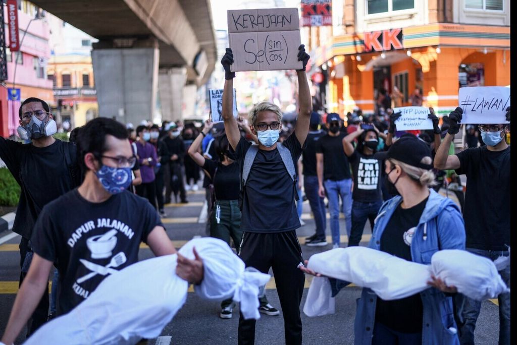 Sejumlah warga berunjuk rasa di Kuala Lumpur, Malaysia, Sabtu (31/7/2021). Mereka menggugat pemerintah yang dianggap tidak sigap menangani Covid-19. Ini dilakukan ketika pemerintah menerapkan penguncian ketat yang membatasi publik.