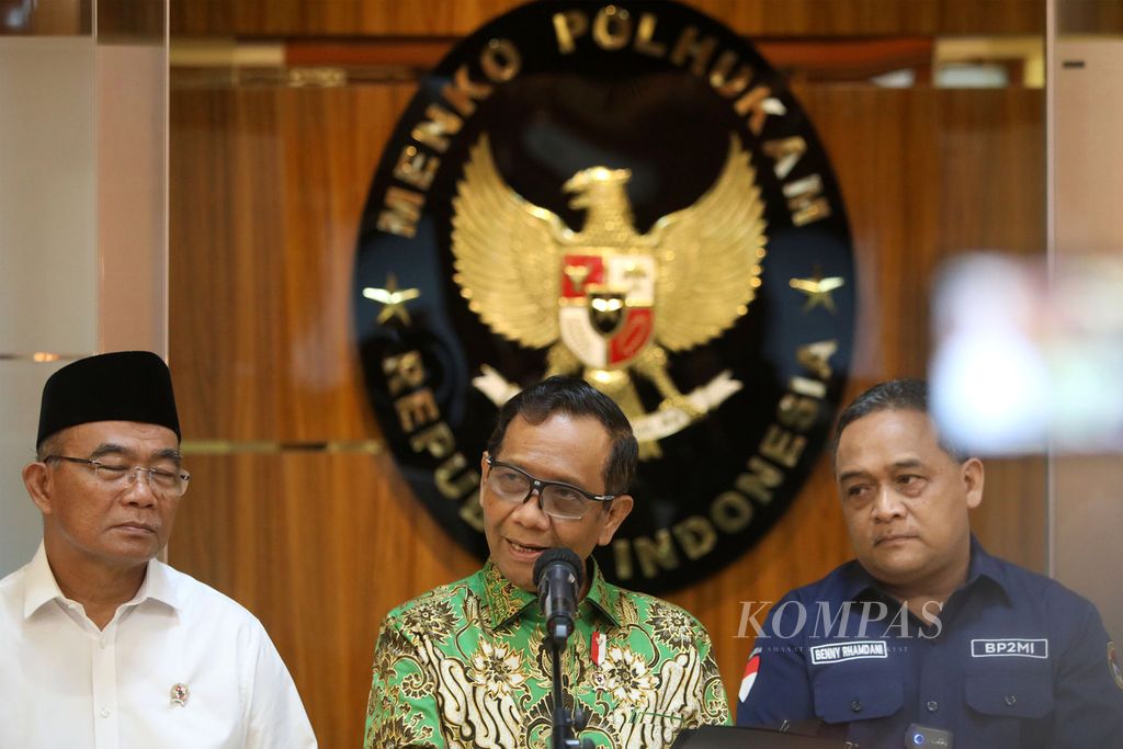 Menkopolhukam Mahfud MD (tengah) bersama Menko PMK Muhadjir Effendy (kiri) dan Kepala BP2MI Benny Rhamdani memberikan keterangan kepada media terkait penanganan Tindak Pidana Perdagangan Orang (TPPO) di Kantor Kemenko Polhukam, Jakarta, Selasa (4/7/2023).
