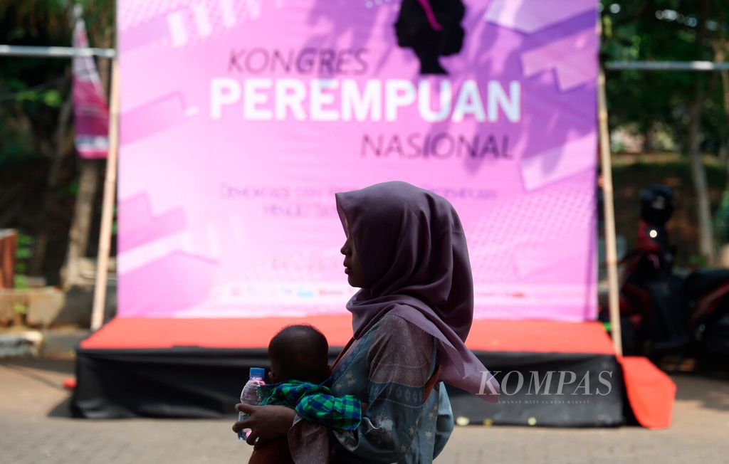 Peserta menggendong anaknya saat akan mengikuti Kongres Perempuan Nasional di Kampus Universitas Diponegoro, Kota Semarang, Jawa Tengah, Sabtu (26/8/2023). 