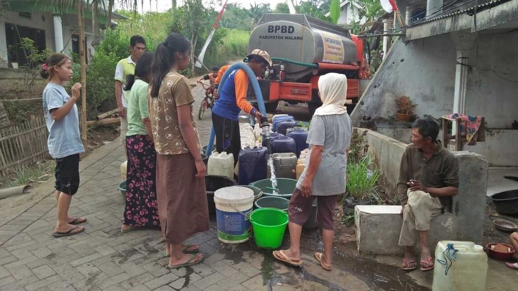 Petugas Badan Penanggulangan Bencana Daerah Kabupaten Malang, Jawa Timur, mengedrop air bersih kepada warga di Desa Klampok, Kecamatan Singosari, Minggu (10/9/2023).