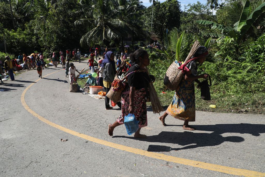 Warga membawa pulang aneka barang hasil membeli maupun barter di Pasar Mambunibuni di Distrik Kokas, Kabupaten Fakfak, Papua Barat, Sabtu (19/6/2021). 