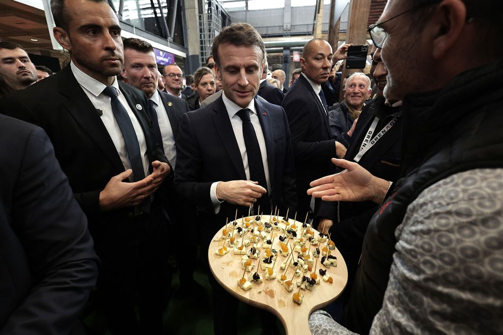 Presiden Perancis Emmanuel Macron (tengah) ditawari keju dalam Pameran Pertanian Internasional di Paris pada 24  Februari 2024