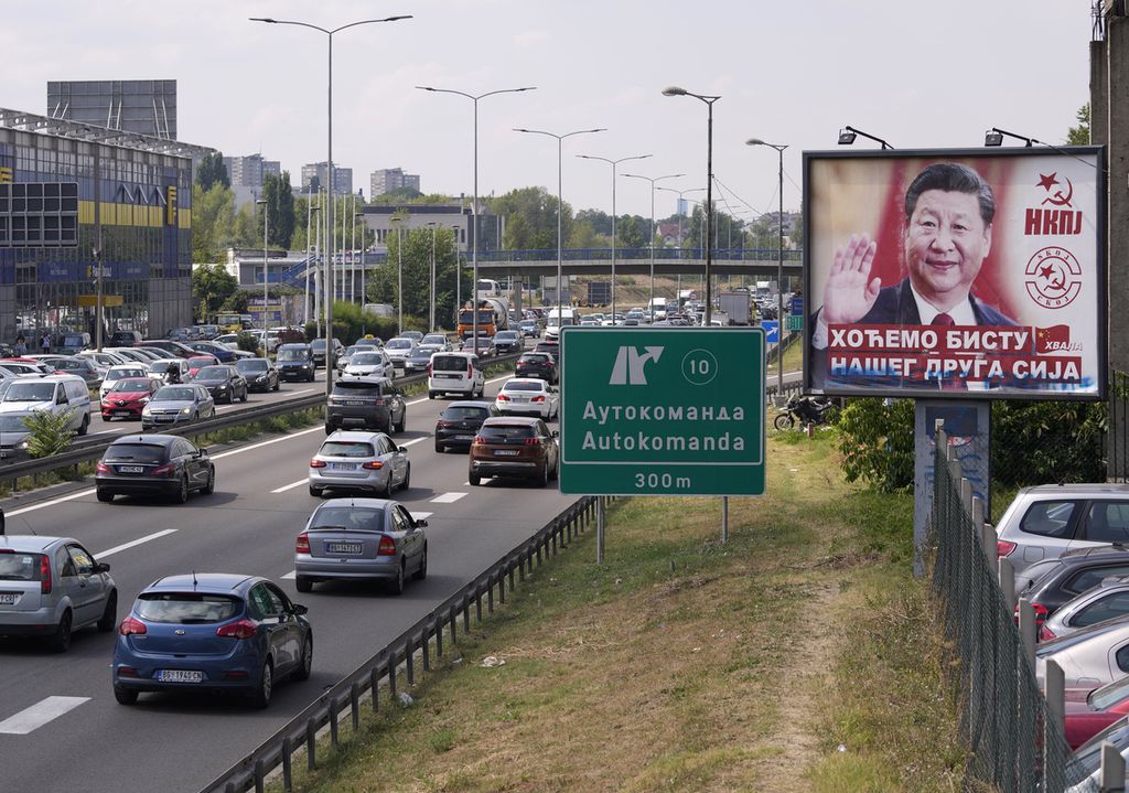 Arsip foto pada 26 Agustus 2021 menampilkan kendaraan melaju di sebelah papan iklan bergambar Presiden China Xi Jinping di Beograd, Serbia. Xi kembali berkunjung ke Serbia pada 7 Mei 2024. 