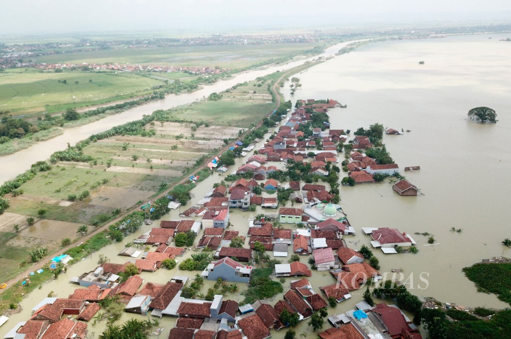 The houses of residents are still submerged in 150-200 centimeter-deep floods caused by the breach of the Wulan River embankment a few days ago in Karanganyar District, Demak Regency, Central Java, on Monday (12/2/2024).