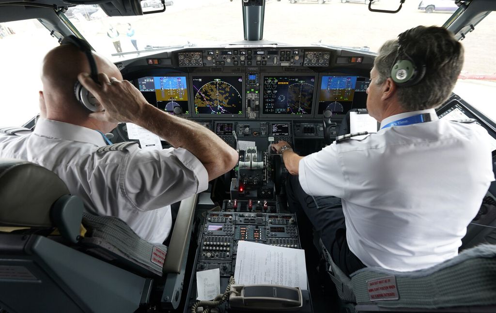 Pilot American Airlines Pete Gamble (kiri) dan kopilot John Konstanzer melakukan pemeriksaan prapenerbangan di kokpit jet Boeing 737 Max sebelum lepas landas dari bandara Dallas Fort Worth di Grapevine, Texas, AS, Rabu (2/12/2020). 