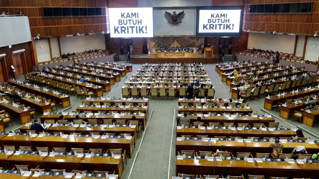 Deretan kursi kosong dan tulisan "Kami Butuh Kritik" dilayar monitor mewarnai jalannya Rapat Paripurna ke-18 masa persidangan III tahun sidang 2017-2018 di Kompleks Parlemen, Senayan, Jakarta, Rabu (14/2).