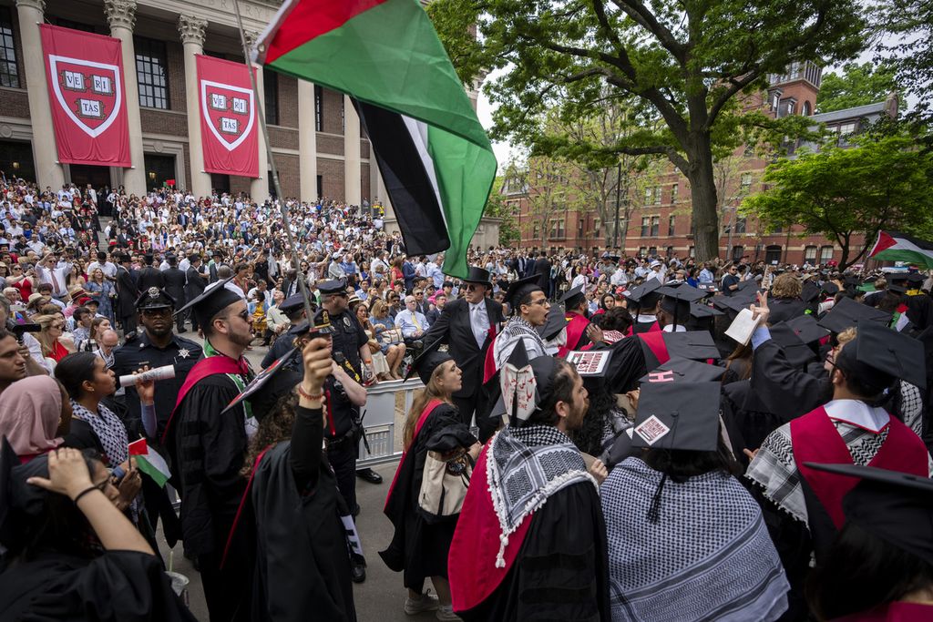 Harvard University's male and female graduates raised the Palestinian flag while shouting slogans in support of Palestine as they chose to leave the graduation area in protest during the graduation ceremony on the Harvard University campus in Cambridge, Massachusetts, USA on May 23, 2024.