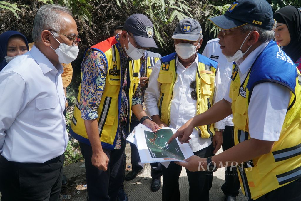 Menteri PUPR Basuki Hadimuljono (dua dari kanan) didampingi jajarannya mengamati peta rencana pembangunan flyover/jembatan layang di Jalur Sitinjau Lauik, Kota Padang, Sumatera Barat, Rabu (2/11/2022). 
