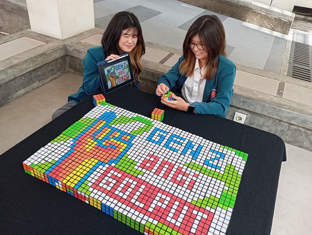 Two female students from Universitas Surabaya assembled 150 rubik's cubes as an installation for a campaign aimed at voters, particularly generation Z, to exercise their right to vote in the general election on February 14, 2024.