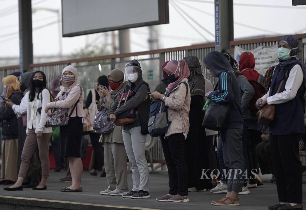Penumpang komuter menunggu keberangkatan KRL di Stasiun Bekasi, Jawa Barat, Senin (8/6/2020) pukul 06.02. PT Kereta Commuter Indonesia menyiapkan petugas dan marka di stasiun ataupun di dalam KRL sebagai pedoman bersama dalam menjaga jarak. 