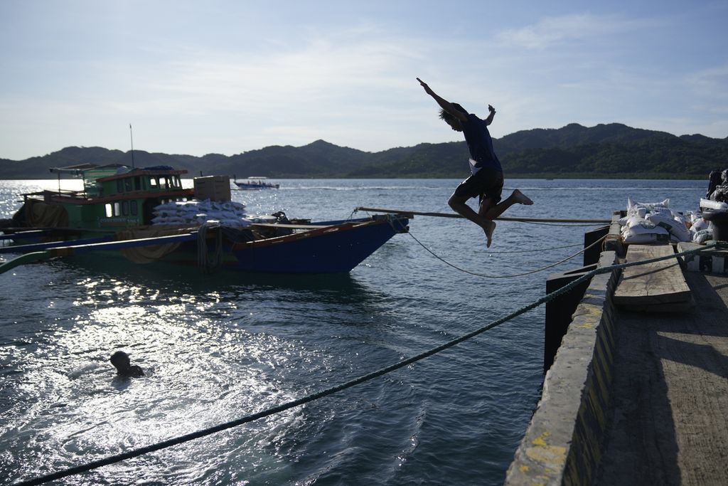 Seorang anak laki-laki melompat di pelabuhan kota pesisir Santa Ana, Provinsi Cagayan, Filipina utara, 7 Mei 2024.