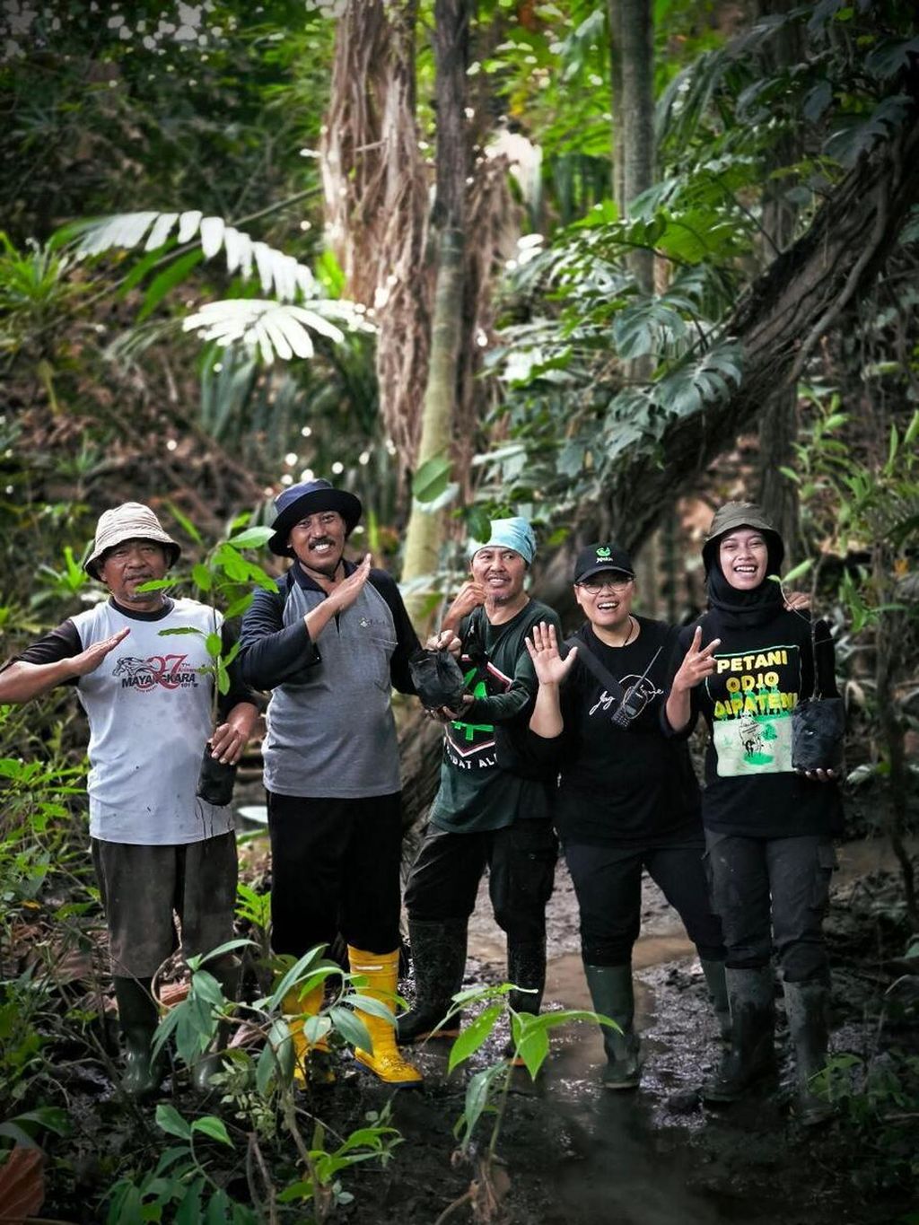 Fainta Susilo Negoro (second from the right) is pictured with volunteer friends after performing restoration work at a location in Java Island, some time ago.