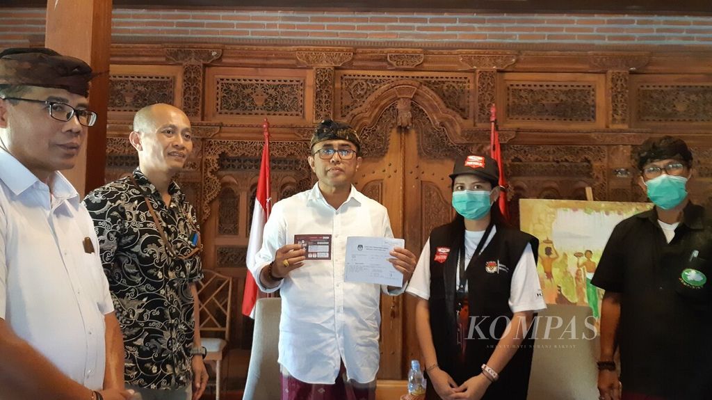 Wali Kota Denpasar I Gusti Ngurah Jaya Negara (tengah) menunjukkan surat tanda bukti dan stiker coklit seusai didata petugas pemutakhiran data pemilih (PPDP). Proses coklit di rumah Jaya Negara juga dihadiri Ketua KPU Kota Denpasar I Wayan Arsa Jaya (kedua, kiri).
