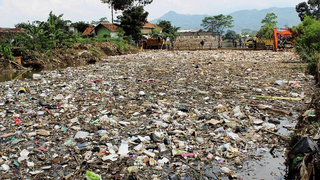 Tumpukan sampah menutupi Sungai Cikapundung di Desa Citeureup, Kecamatan Dayeuhkolot, Kabupaten Bandung, Jawa Barat, Jumat (2/3/2018). Sampah berasal dari kawasan hulu yang terbawa aliran sungai saat hujan.