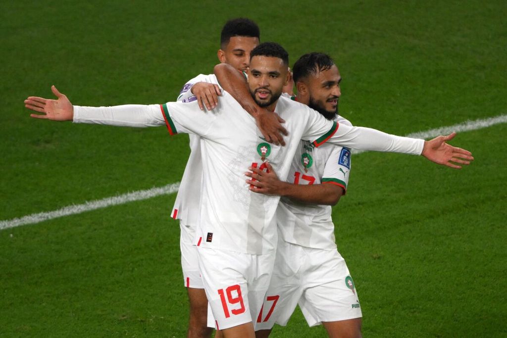 Penyerang Maroko, Youssef En Nesyri (tengah), dan gelandang Azzedine Ounahi (kiri) melakukan selebrasi dalam pertandingan Grup F Piala Dunia Qatar antara Kanada dan Maroko di Stadion Al Thumama, Doha, Kamis (1/12/2022).  