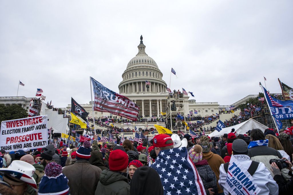 Para pendukung setia Presiden Donald Trump menerobos gedung Capitol Hill di Washington, AS, pada Rabu (6/1/2021).