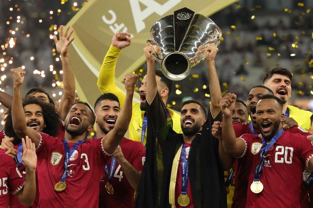 Penyerang Qatar Hassan Al-Haydos mengangkat trofi Piala Asia AFC Qatar 2023. 