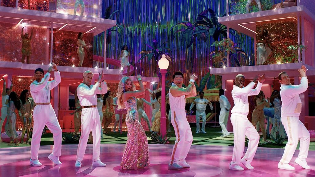 Scene of <i>Barbie </i>and the Kens dancing at a party at the Dreamhouse.