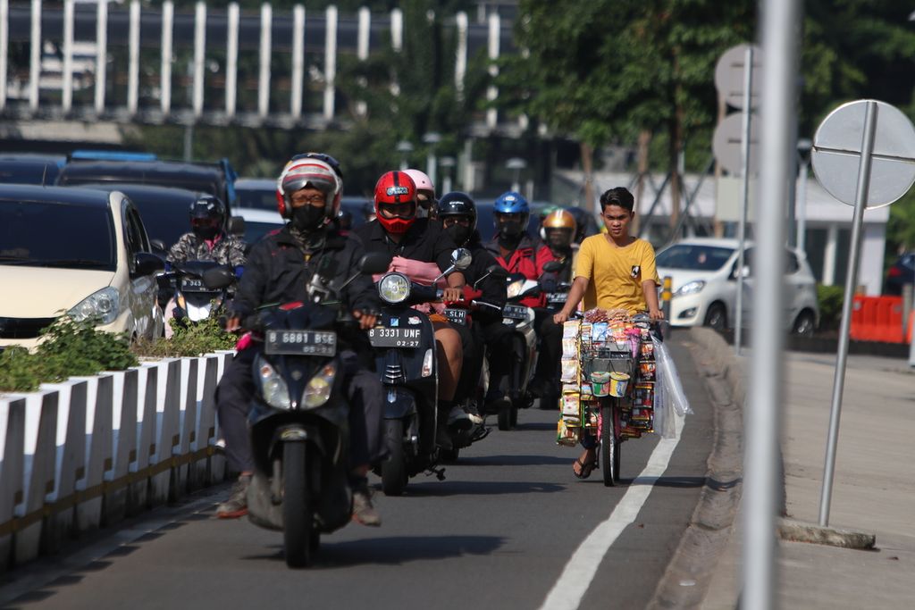 Pesepeda dan pengendara sepeda motor yang menerobos jalur sepeda di kawasan Senayan, Jakarta, Sabtu (29/10/2022).