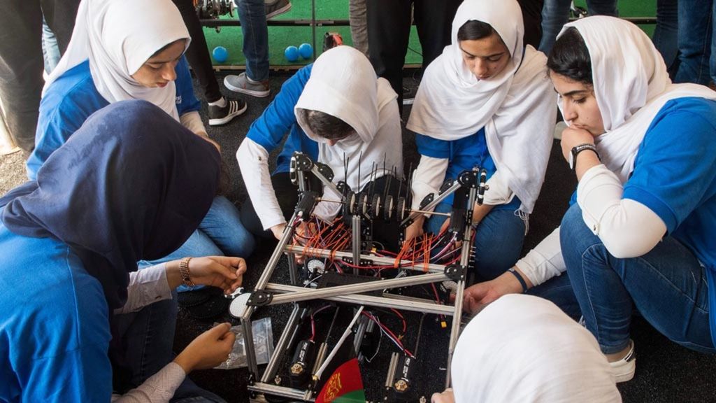 Tim robotika putri Afghanistan mengutak-atik karya mereka untuk ajang robotika FIRST Global Challenge 2017 di Washington DC, AMerika Serikat pada tanggal 17 Juli 2017. (AFP PHOTO / PAUL J. RICHARDS)