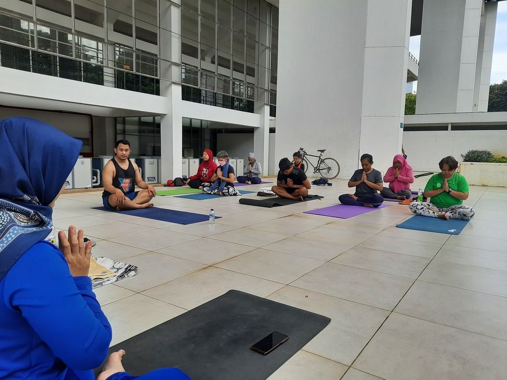 Instruktur yoga Ahmad Koedri (31) menutup sesi kelas Zen Thai Massage dalam komunitas YogaDogether di Stadion Akuatik, Gelora Bung Karno, Jakarta, Minggu (20/11/2022). Ia memperkirakan, popularitas yoga masih akan terus meningkat karena gerakan-gerakannya yang terus berkembang, sehingga tak membosankan bagi pecinta olahraga ini.