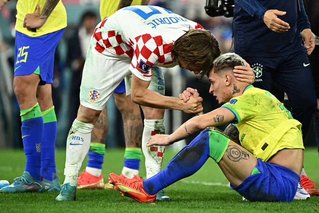 Gelandang Kroasia Luka Modric memberi semangat kepada pemain Brasil Antony yang lesu karena tersingkir di babak perempat final lewat adu pinalti melawan Kroasia yang digelar di Stadion Kota Pendidikan, Al-Rayyan, Qatar, Jumat (9/12/2022). 