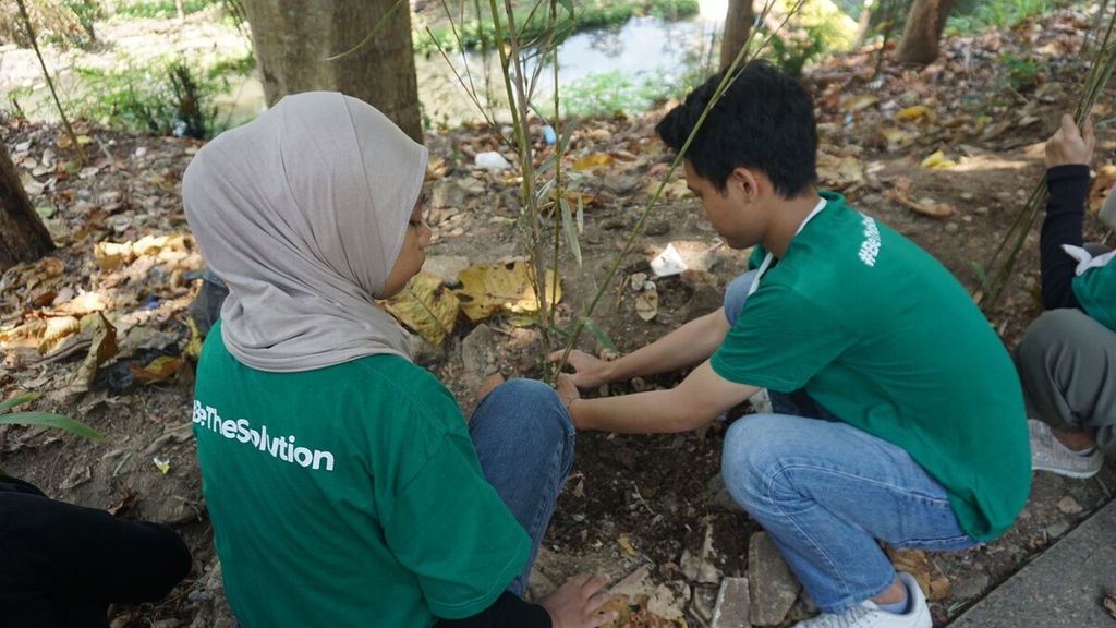 Relawan bersama-sama menanam pohon bambu.