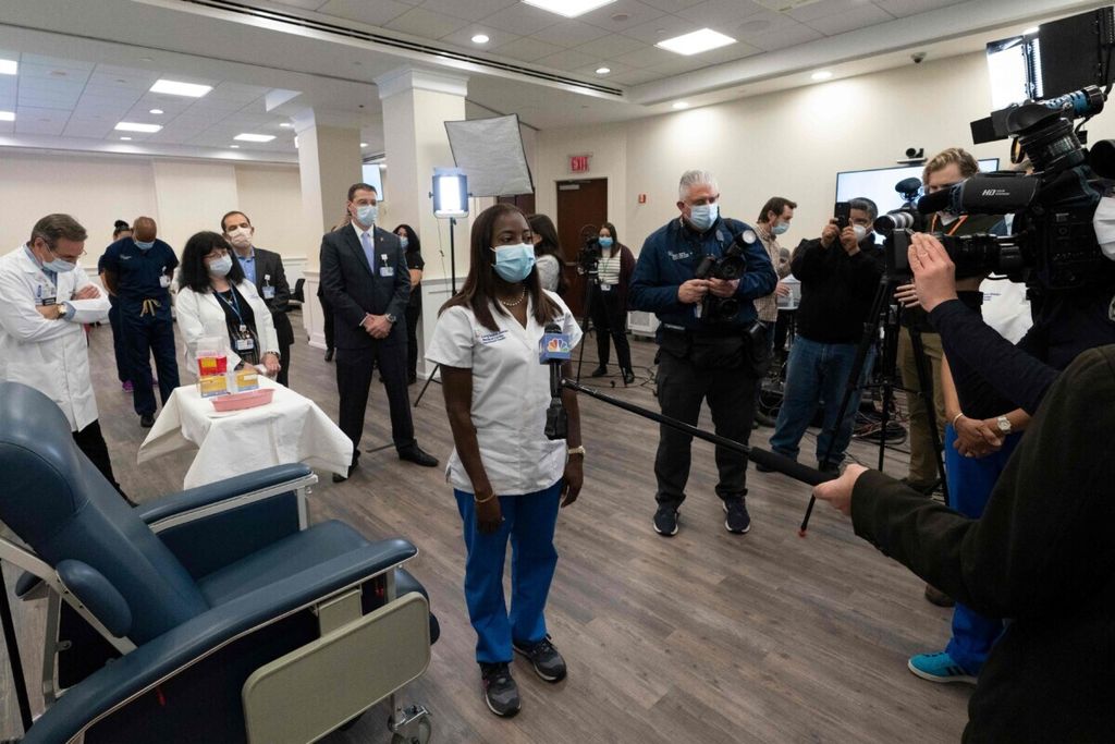 Perawat Sandra Lindsay (tengah) diwawancarai wartawan seusai menjalani suntikan vaksin Covid-19 di Long Island Jewish Medical Center, wilayah Queens, New York, AS, 14 Desember 2020. 