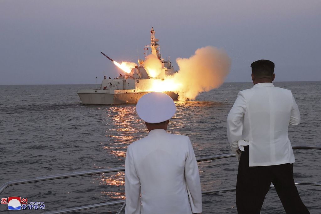 Dalam foto tanpa keterangan tanggal yang dirilis pada 21 Agustus 2023 oleh Pemerintah Korea Utara ini, Pemimpin Korea Utara Kim Jong Un (kanan) menyaksikan uji coba penembakan rudal strategis dari kapal. 