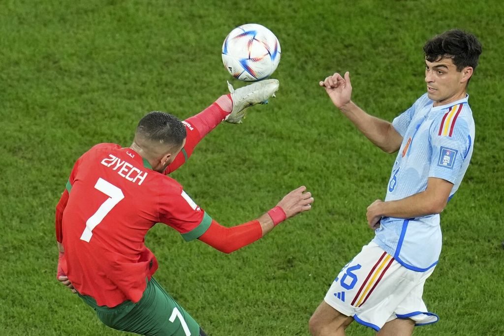 Pemain Maroko Hakim Ziyech (kiri) mengontrol bola melewati pemain Spanyol Pedri dalam babak 16 besar Piala Dunia Qatar di Stadion Education City di Al Rayyan, Qatar, Selasa (6/12/2022). Maroko memenangi laga melalui adu penalti dengan skor 3-0 (0-0) 