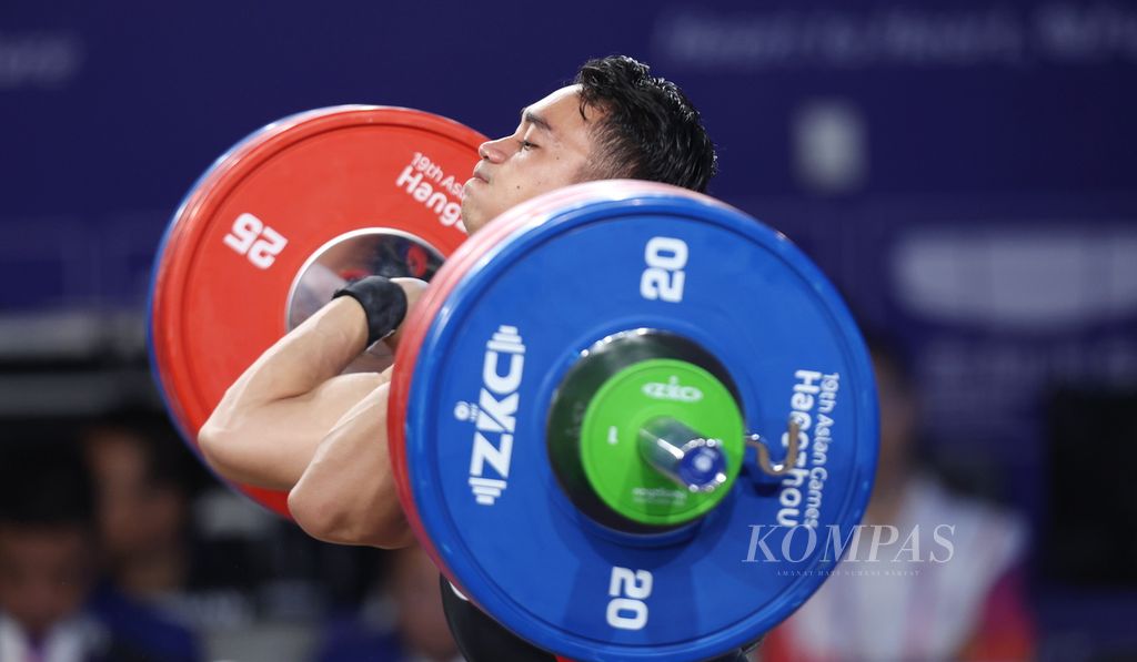 Lifter Indonesia, Ricko Saputra, tampil dalam final kelas 61 kg putra di Xiaoshan Sports Centre Gymnasium, Hangzhou, Provinsi Zhejiang, China, Minggu (1/10/2023). Ricko berada di urutan ke-7 dengan total angkatan 288 kg, <i>snatch</i> (128 kg) dan <i>clean and jerk</i> (160 kg). Lifter China, Li Fabin, meraih emas dengan total angkatan 310 kg, <i>snatch</i> (143 kg) dan<i> clean and jerk</i> (167 kg). 