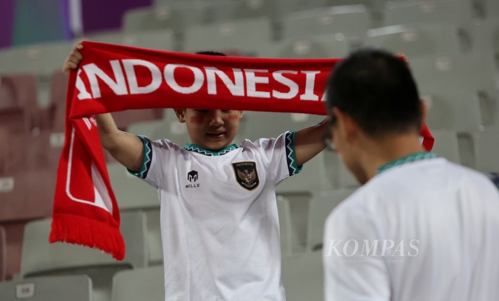 Gaya suporter cilik Indonesia saat mendukung timnas Indonesia melawan Vietnam di Stadion Abdullah bin Khalifa, Doha, Qatar, Jumat (19/1/2024). 