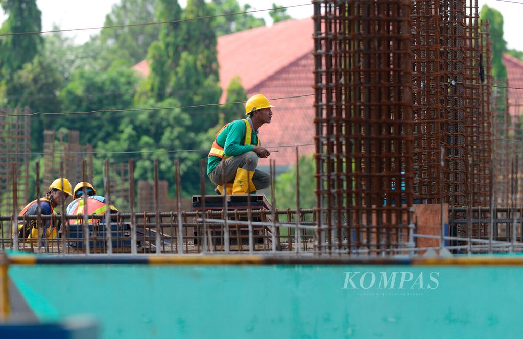Salah satu pekerja yang mengawasi pemasangan tiang baja pada proyek konstruksi gedung di Tembalang, Kota Semarang, Jawa Tengah, Rabu (10/5/2023).