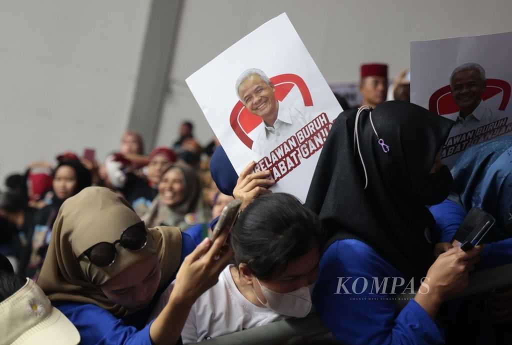 Sukarelawan Jokowi membawa poster bakal calon presiden dari PDI Perjuangan, Ganjar Pranowo, saat halalbihalal di Hall Basket, Gelora Bung Karno, Jakarta, Sabtu (14/5/2023). 