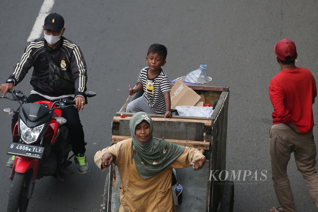 Pemulung mengajak anaknya untuk memulung di kawasan Pulo Gebang, Jakarta Timur, Jumat (16/2/2024). Menurut catatan Badan Pusat Statistik, pada Maret 2023, tingkat kemiskinan ekstrem sebesar 1,12 persen. Pemerintah menargetkan kemiskinan ekstrem hilang pada tahun ini.