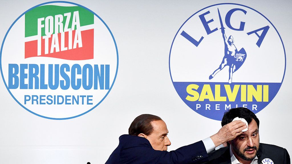 Pemimpin Forza Italia (Italia) Silvio Berlusconi (kiri) menyeka dahi pemimpin partai sayap kanan Liga Matteo Salvini, saat konferensi pers bersama dengan pemimpin partai sayap kanan Brothers dari Italia (tak terlihat) di Tempio di Adriano di Roma, Kamis (1/3).