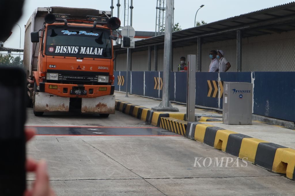Sebuah truk bersiap melintasi alat pengukur beban (<i>weigh in motion</i>) di Gerbang Tol Palimanan, Kabupaten Cirebon, Jawa Barat, Kamis (10/2/2022). Alat itu dapat mendeteksi kendaraan yang beban dan dimensinya melebihi ketentuan.