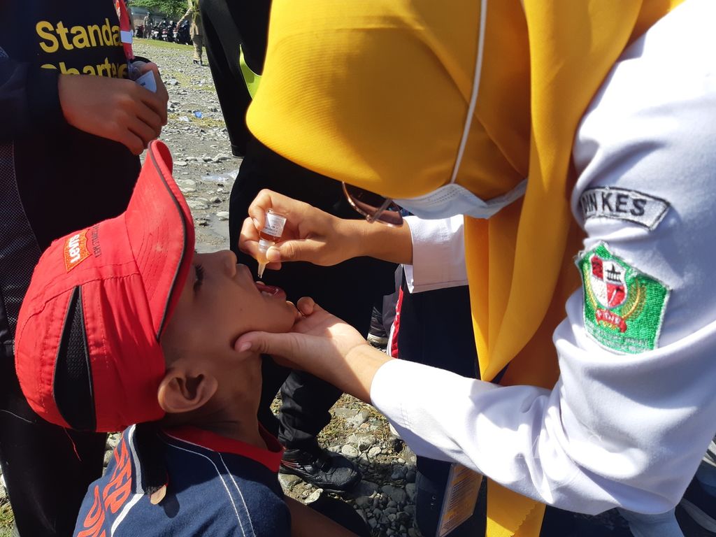Tenaga kesehatan meneteskan imunisasi polio kepada salah seorang anak sekolah dasar dalam sub-Pekan Imunisasi Nasional di Kabupaten Pidie, Aceh, Senin (28/11/2022). Imunisasi massal dilakukan pasca-penemuan empat kasus positif polio di kabupaten itu.