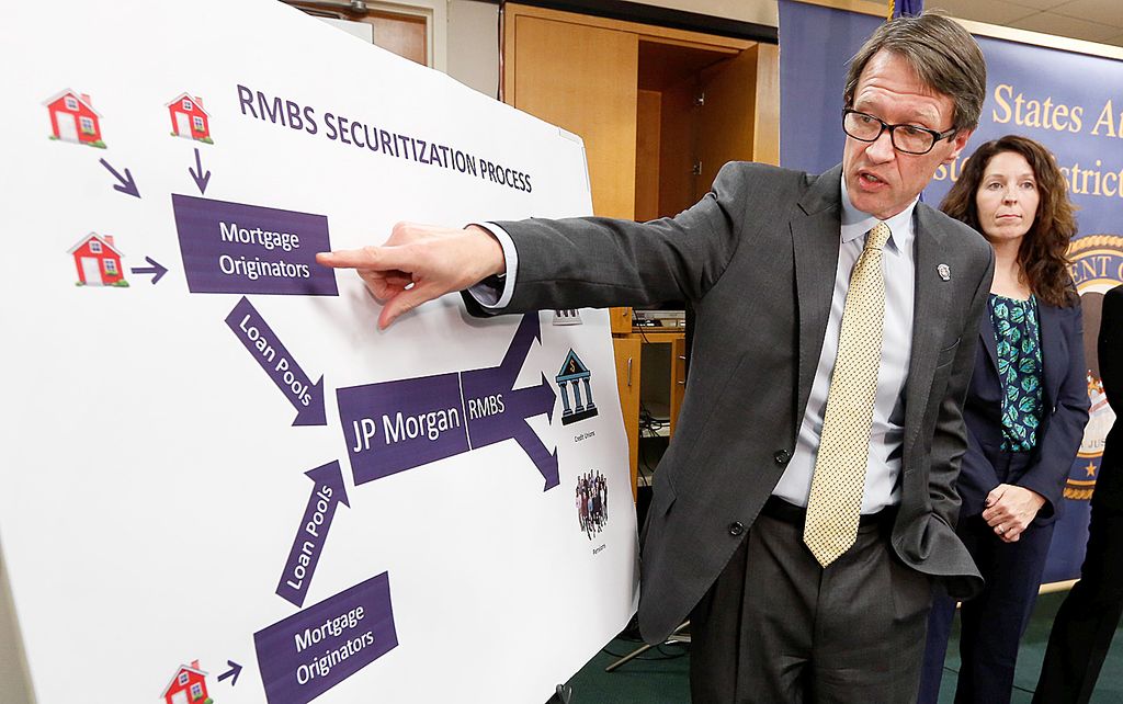 Benjamin Wagner, the United States Attorney for the Eastern District of California, points towards a chart showing how home mortgages were bundled as defective mortgage-backed securities during a news conference to discuss the $13 billion settlement with JPMorgan Chase & Co., in Sacramento, Calif., Tuesday, Nov. 19, 2013. The settlement, the largest ever reached between the government and a corporation, is the latest chapter in the bursting of the housing bubble in 2007. Still to come is a decision on whether federal criminal charges will be filed against JP Morgan. 