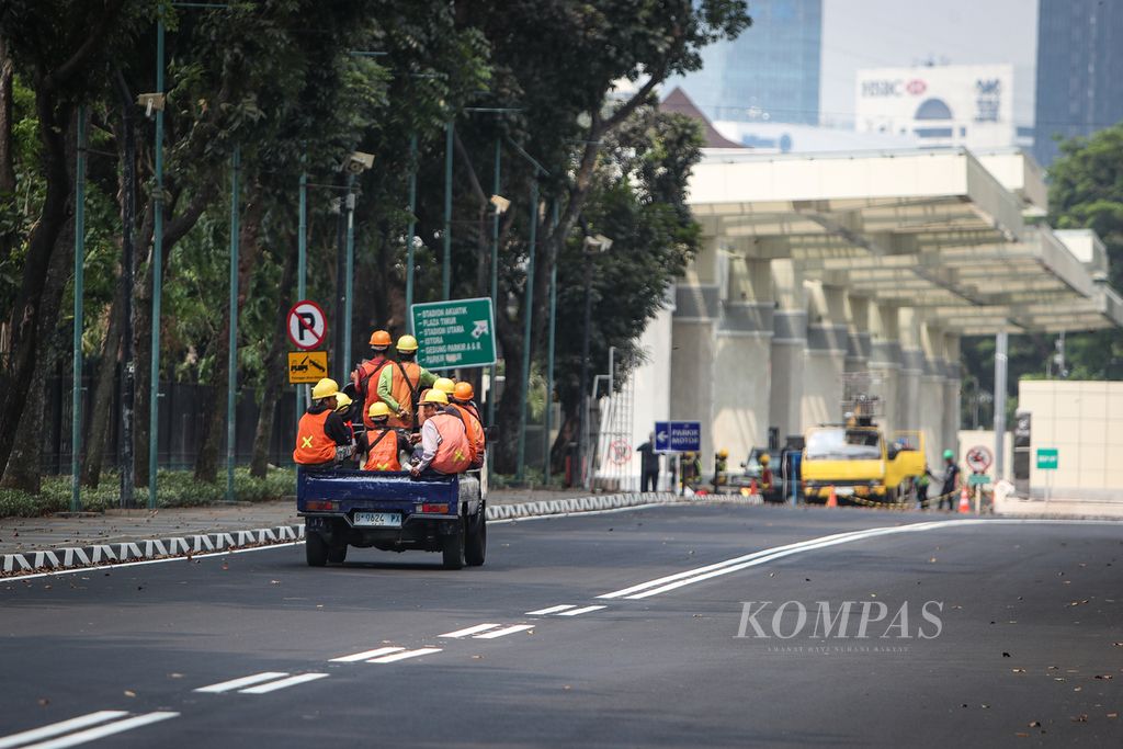 Mobil bak terbuka yang mengangkut pekerja proyek melintas di kawasan Gelora Bung Karno, Senayan, Jakarta, Sabtu (26/8/2023). Pengelola kawasan Gelora Bung Karno membatasi akses kendaraan bermotor ke kawasan tersebut mulai pukul 05.00 hingga 22.00. Kebijakan yang berlangsung pada 25 Agustus 2023 hingga 3 September 2023 ini bertujuan untuk mendukung penyelenggaraan Piala KTT ASEAN.