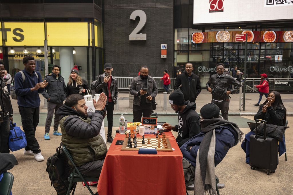 The residents cheered as Tunde Onakoya broke the record for a marathon game of chess lasting 46 hours in Times Square, New York City, USA on Friday (April 19, 2024).