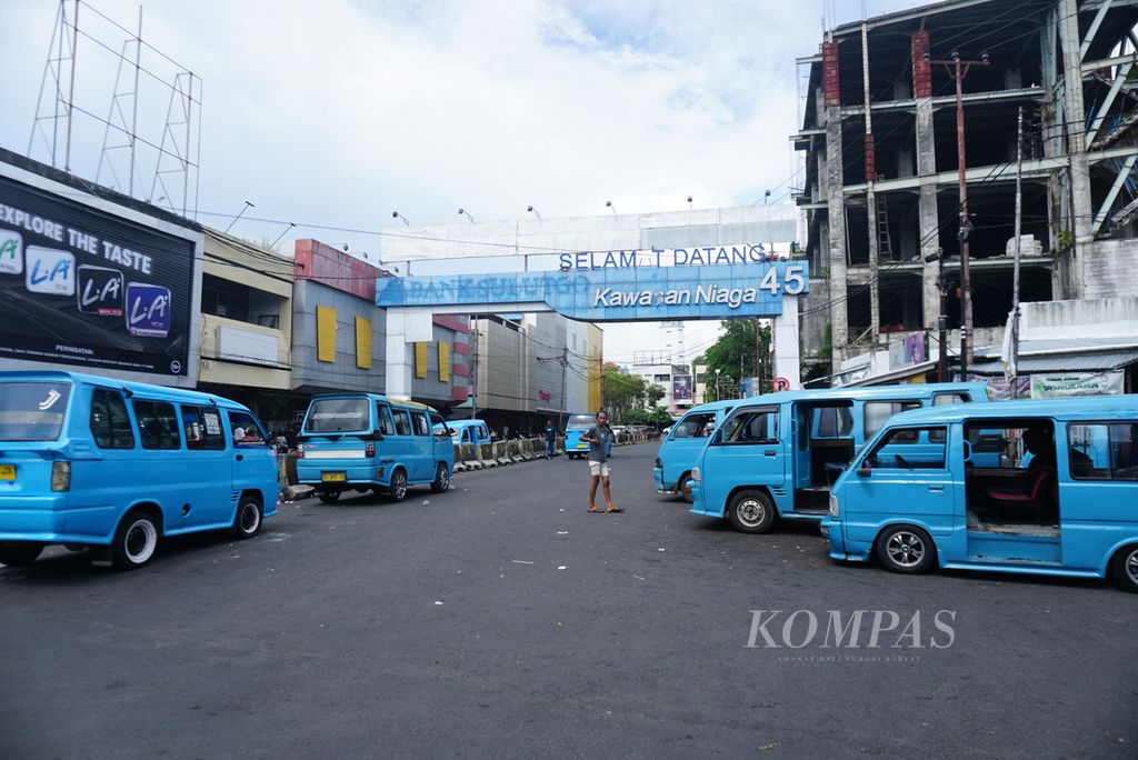 Beberapa mikrolet alias mikro berhenti sambil menunggu penumpang, Rabu (10/5/2023), di belokan menuju area Pasar 45, Manado, Sulawesi Utara. Pasar itu merupakan simpul terbesar trayek mikrolet di Manado.