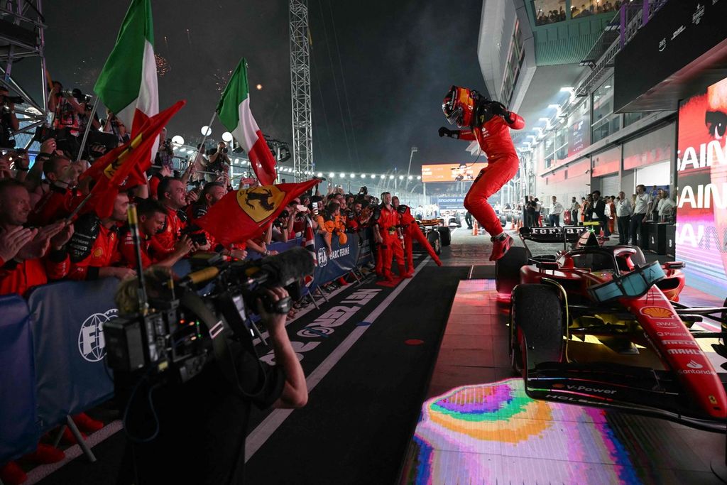 Pebalap Ferrari, Carlos Sainz Jr, melakukan selebrasi setelah finis pertama pada balapan Grand Prix Formula 1 seri Singapura di Sirkuit Jalan Raya Marina Bay, Singapura, Minggu (17/9/2023). 