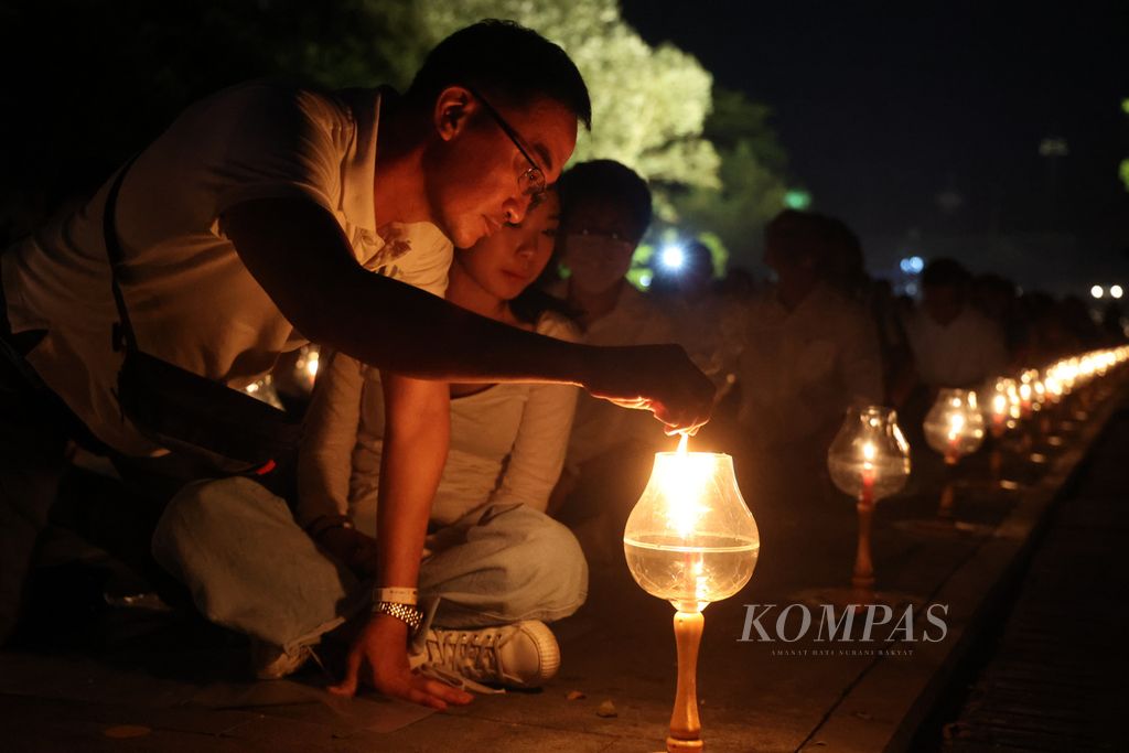 Participants light up ground lanterns while participating in the Waisak Lantern Festival event at the Borobudur Temple complex, Magelang, Central Java, on Sunday (4/6/2023).