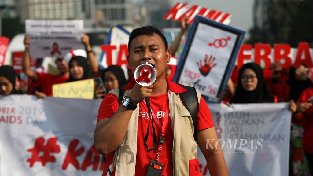  Pawai massa yang tergabung dalam Yayasan AIDS Indonesia memperingati Hari AIDS Internasional di area bebas kendaraan bermotor Jalan MH Thamrin, Jakarta, Minggu (1/12/2019). 