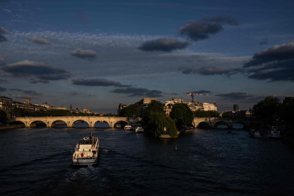 Sebuah kapal berlayar di Sungai Seine, Paris, Selasa (23/4/2024).