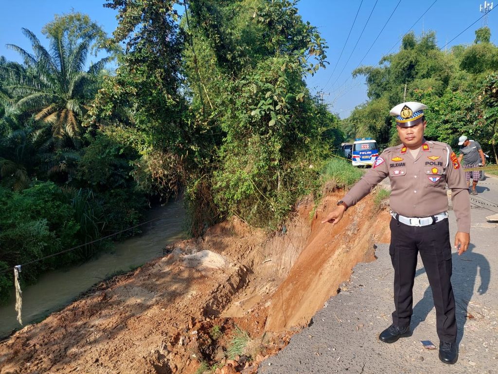 Aparat Polres Lampung Tengah menunjukkan kondisi jembatan yang ambles di Kecamatan Gunung Sugih, Kabupaten Lampung Tengah, Lampung, Senin (15/5/2023). 