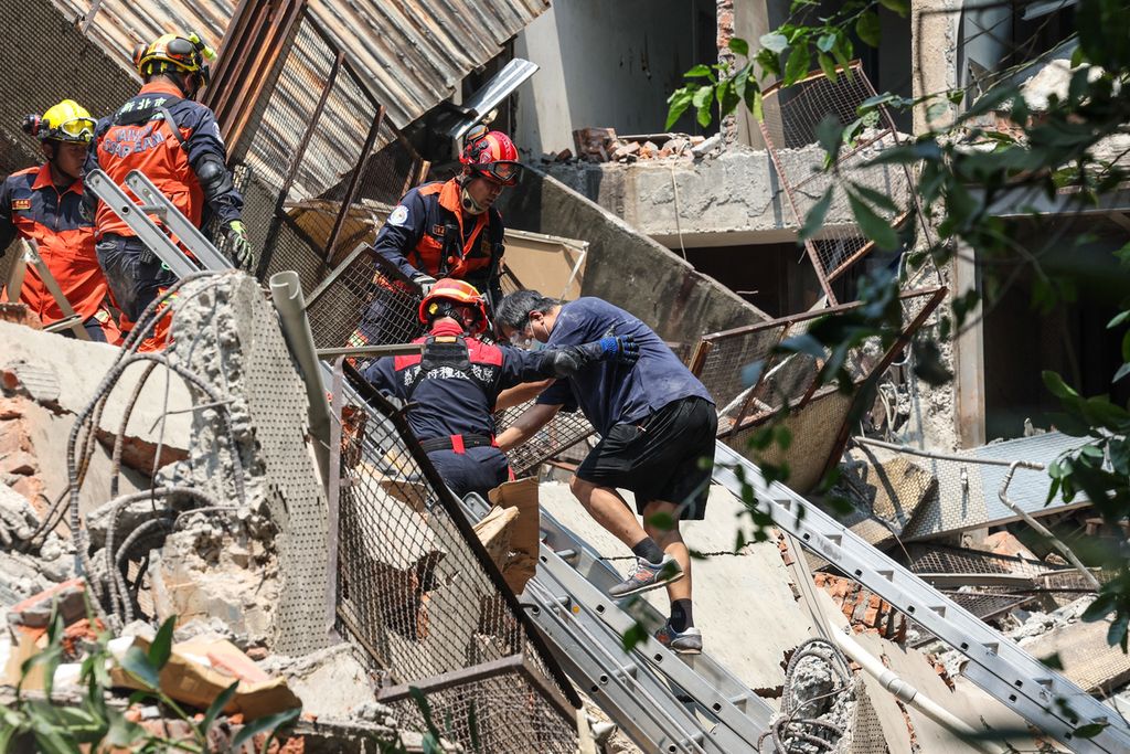 Foto yang diambil kantor berita Taiwan, Central News Agency (CNA), pada Rabu (3/4/2024) ini memperlihatkan petugas tanggap darurat membantu korban selamat di sebuah bangunan yang hancur akibat gempa di New Taipei City, Taiwan. 
