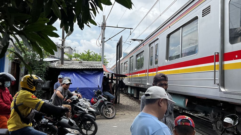 Kereta api melintas di pelintasan sebidang jalur kereta api Pintu Air Petamburan, Jakarta Pusat, Selasa (15/11/2022).