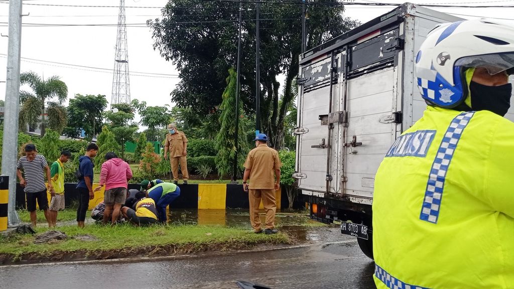 Petugas dan masyarakat membersihkan drainase yang mampet di sekitar Jalan Tjilik Riwut Kilometer 3, Selasa (19/4/2022). Jalur tersebut merupakan jalan Trans-Kalimantan. Walakin, pengguna jalan masih bisa melewati jalur tersebut.